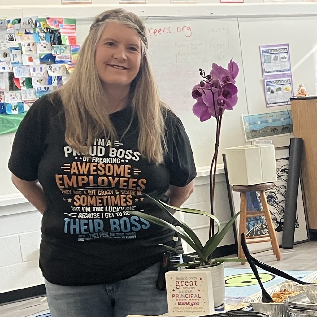 Principal Wheeler Stands with new flower for Principal appreciation day. 
