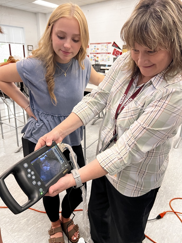 Health science students use new ultrasound equipment to scan pregnant goat in OHS animal science classroom