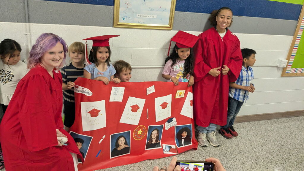 Erwin High graduates walk Woodfin Elementary School halls. 