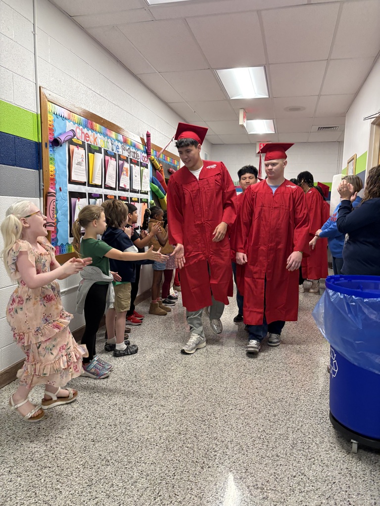 Erwin High graduates walk Woodfin Elementary School halls. 