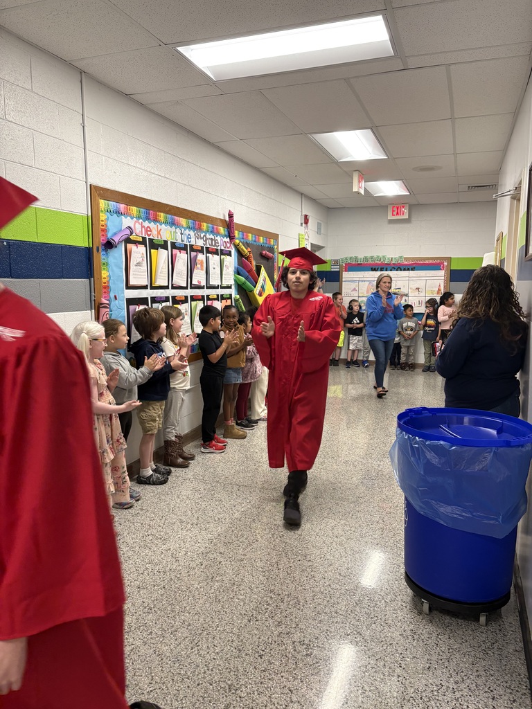 Erwin High graduates walk Woodfin Elementary School halls. 