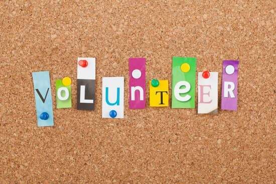 A cork board with the word "volunteer"