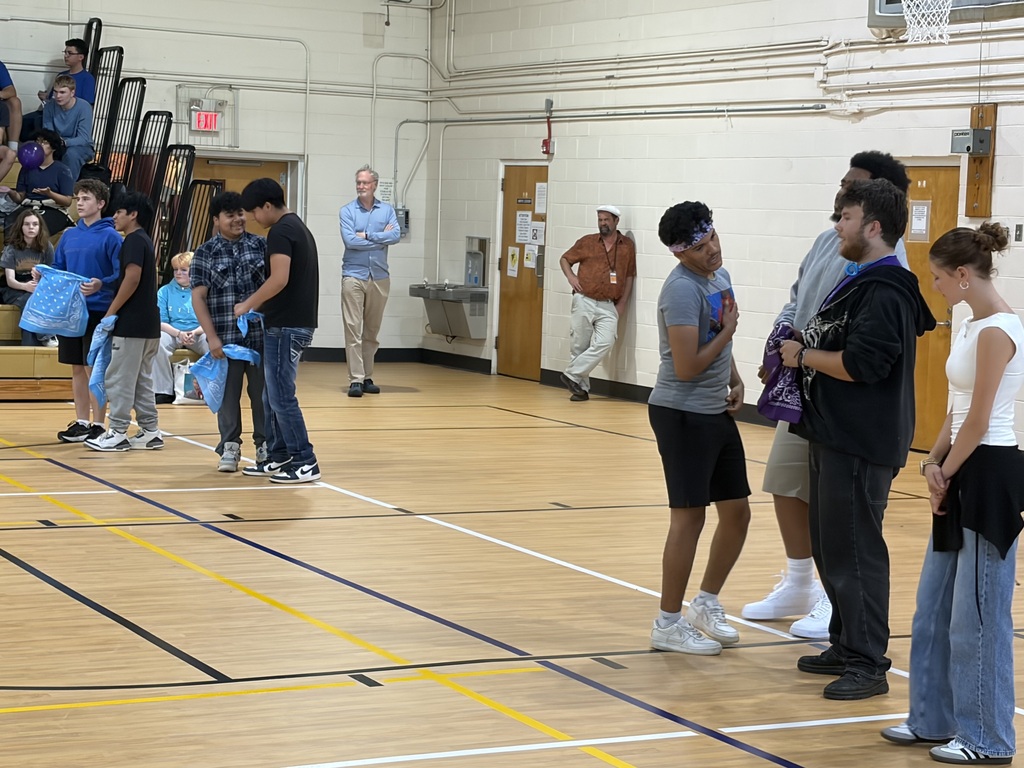 students standing on gym floor 