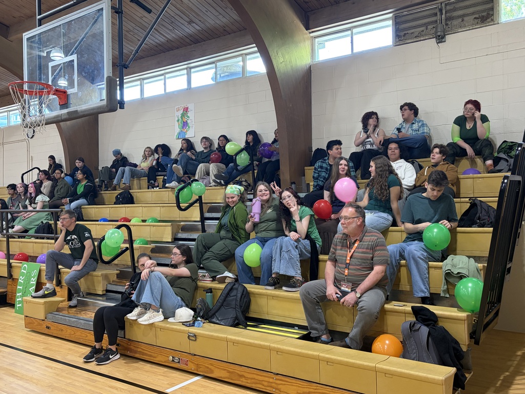 students sitting in gym bleachers