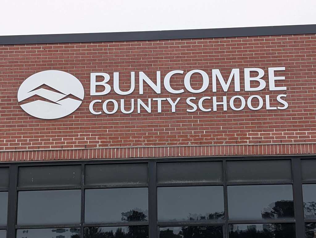 Exterior of the Buncombe County Schools Central Services building with the BCS logo on the bricks.
