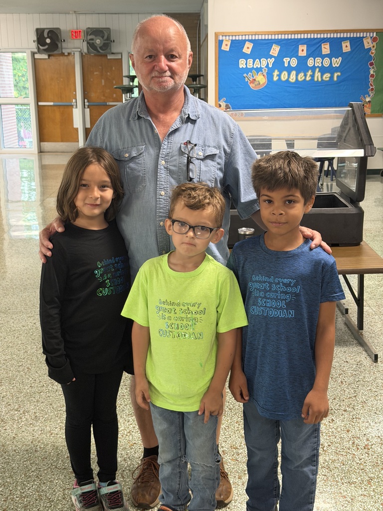 Four people standing smiling for picture. 