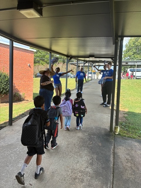 UNCA Lady Bulldogs wishing students a great weekend at dismissal