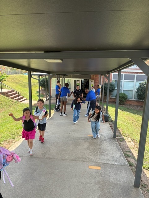 UNCA Lady Bulldogs wishing students a great weekend at dismissal