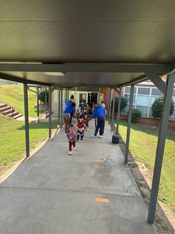 UNCA Lady Bulldogs wishing students a great weekend at dismissal