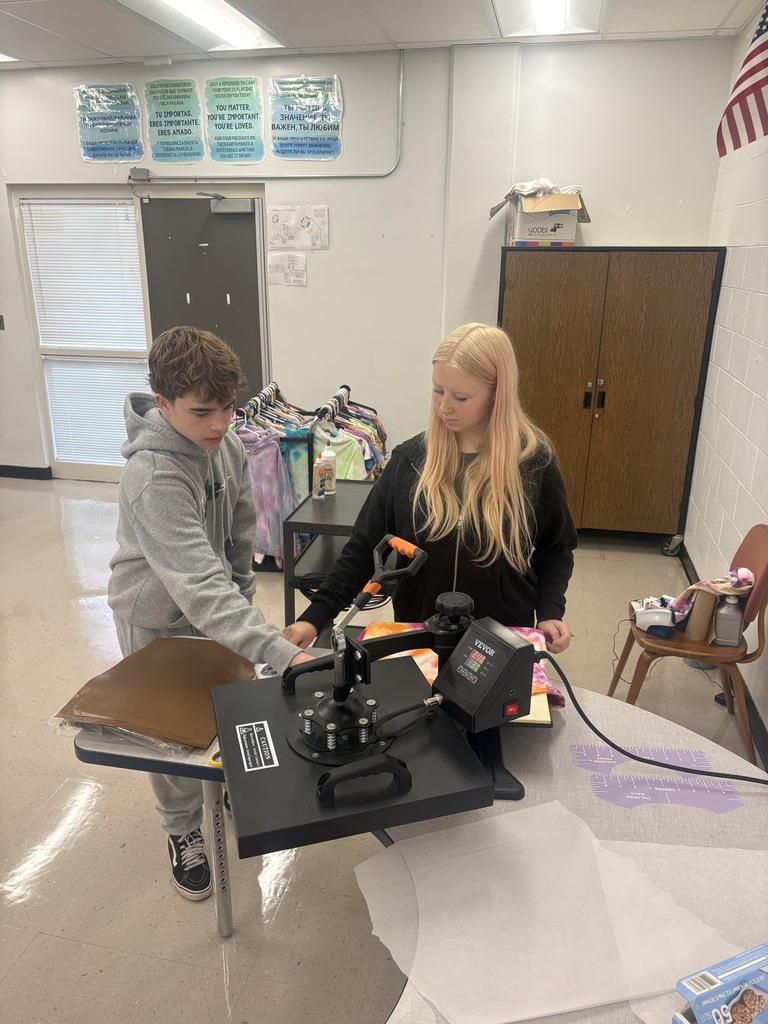Two students pressing shirts