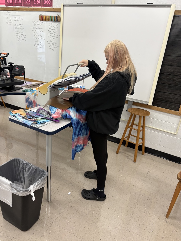 Student pressing a shirt using a t shirt press