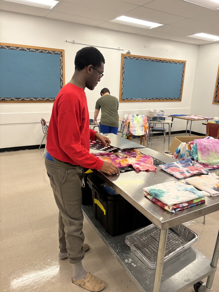 Student folding shirts