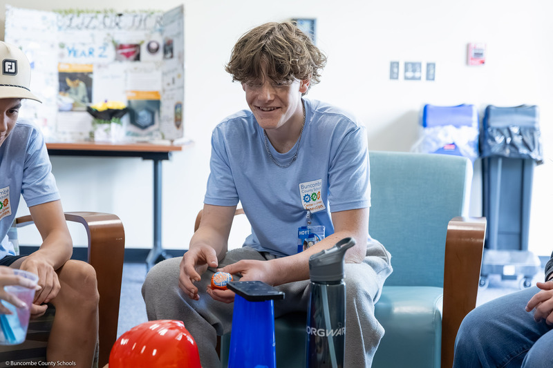 A student holds a ball during an ice breaker activity.