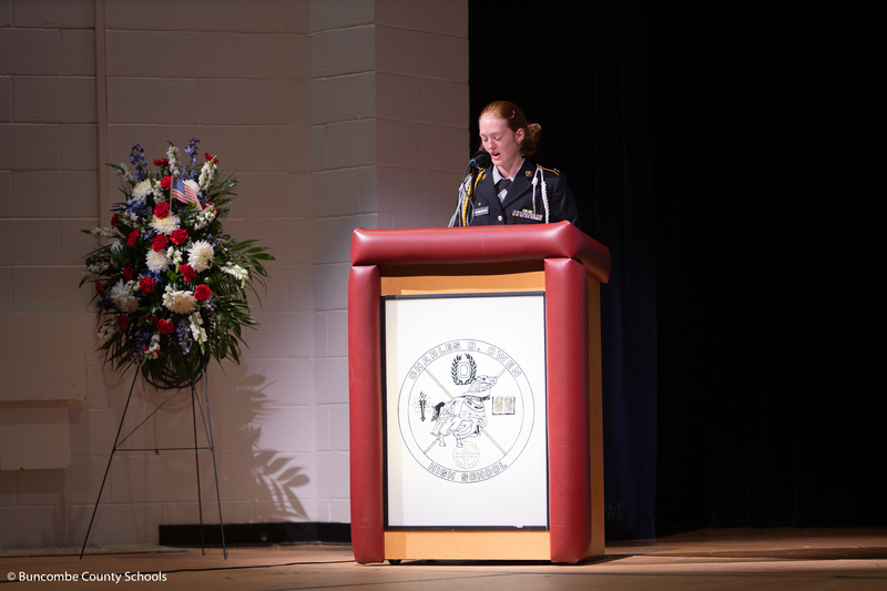 Student standing at a podium giving a speech. 