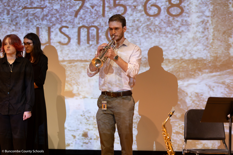 Band director playing taps on the trumpet. 