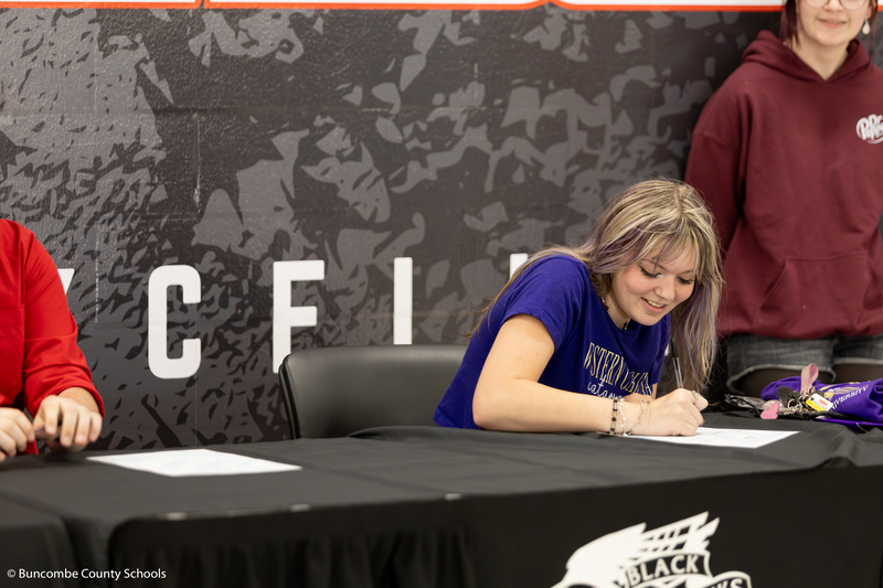 Student signing her letter of intent for Western Carolina University. 