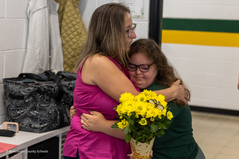 A student hugs Ms. Hyatt