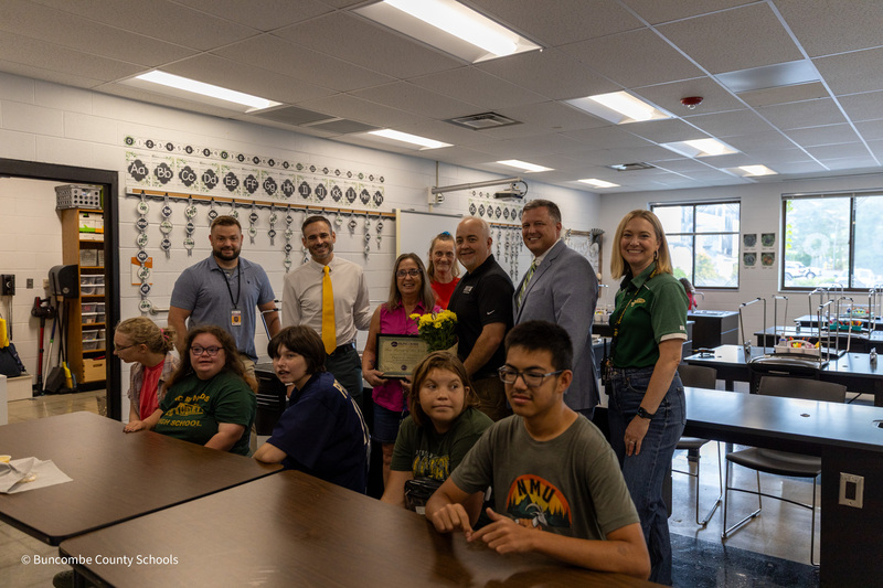 Ms. Hyatt and the Surprise Squad stand behind a row of seated students