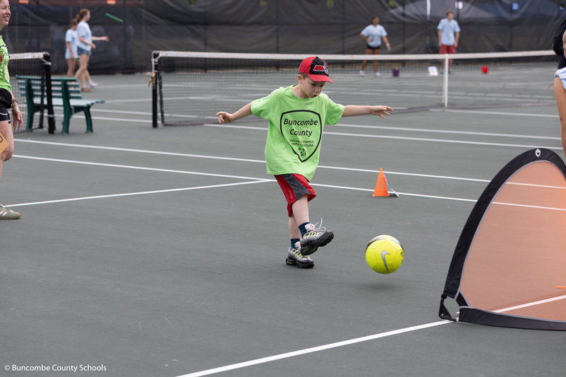 Boy kicking a soccer ball. 