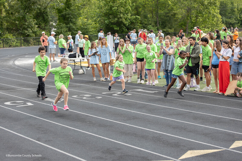 Kids running on the track. 