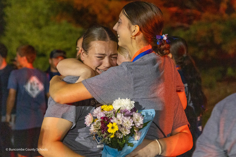 Two players hug as one sheds tears of joy