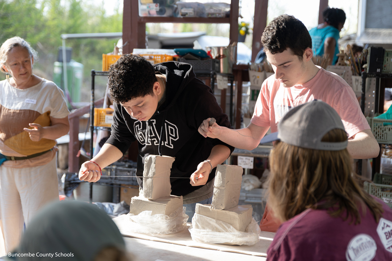 Students cutting clay.