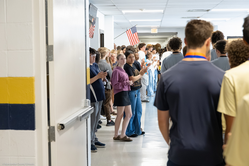 Students cheer as they line the hallway during the parade.