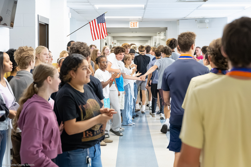 Students cheer as they line the hallway during the parade.