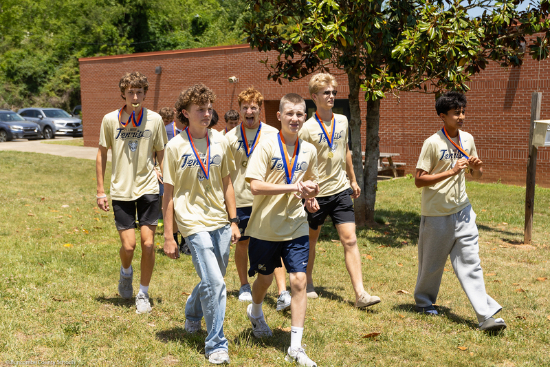 The tennis team outside during the parade.