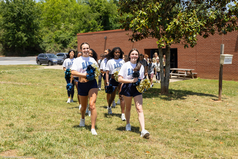 Cheerleaders walk outside during the parade.