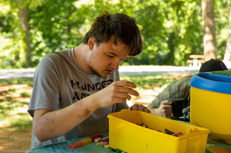 A student builds with Lego blocks.