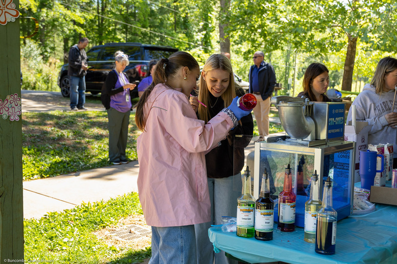 Students operate a cotton candy machine.