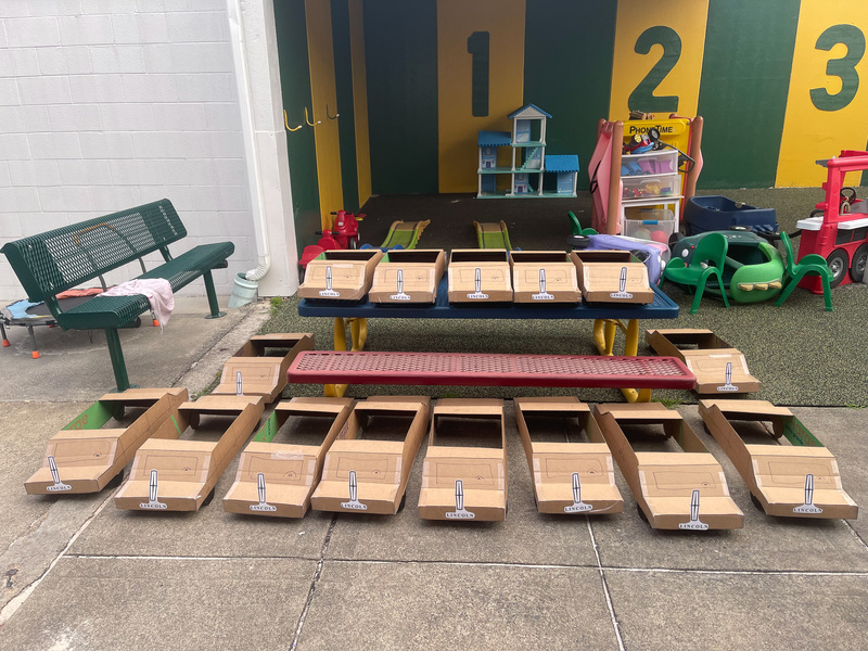 The cardboard cars sitting in front of the Learning Lab