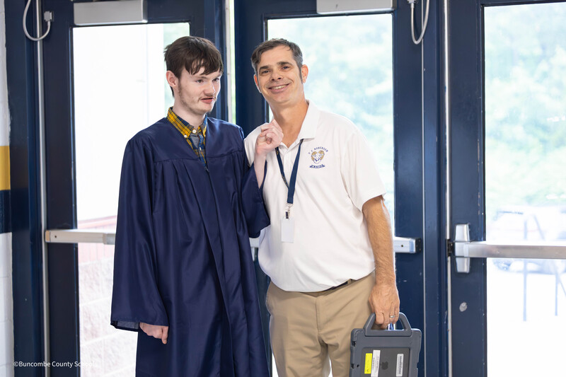 Student smiles alongside his dad