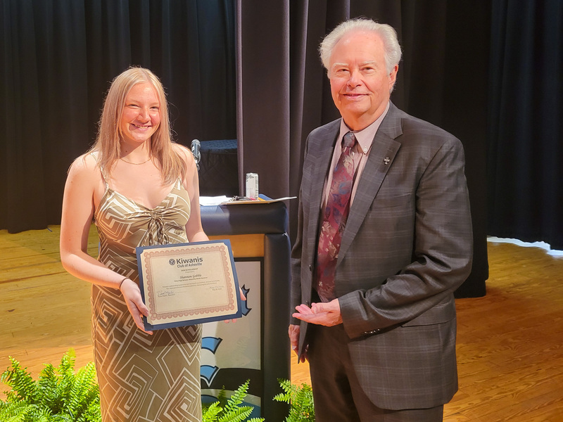 Shannon Gobble stands with a representative of the Kiwanis Club. Shannon is holding her certificate.