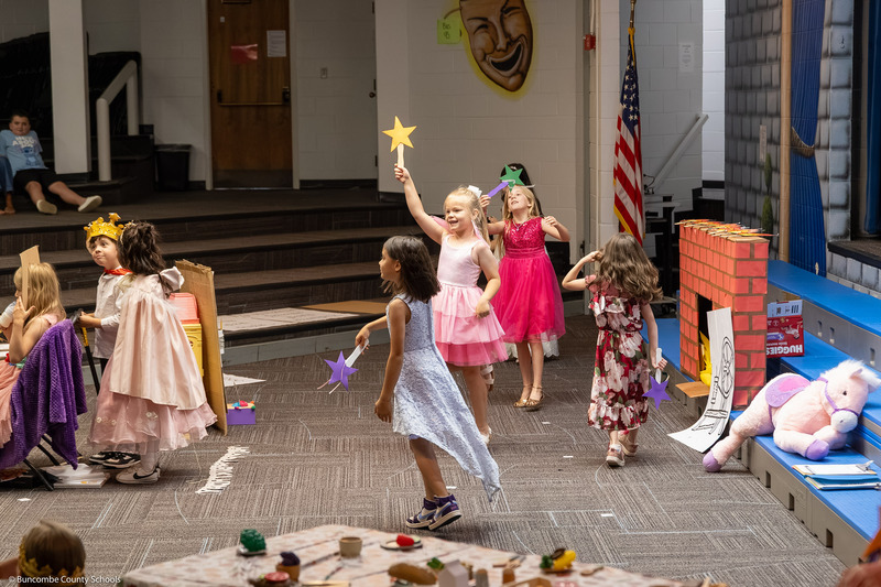 Girls twirl as they dance.