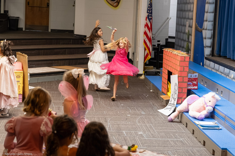 Girls twirl as they dance.