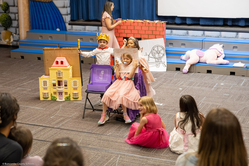 Three students act out a scence.