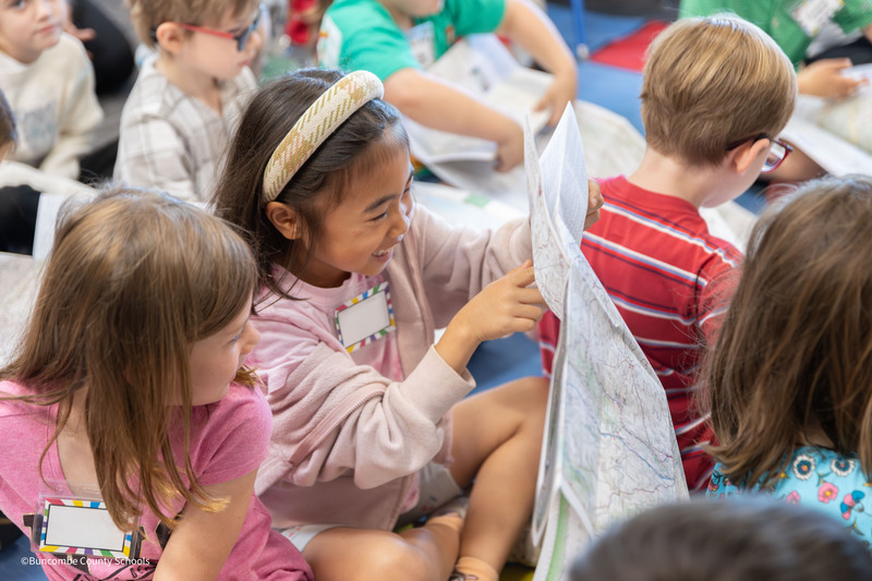 student points to something on map