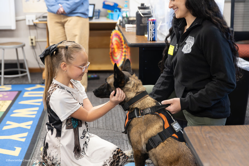 student pets sherry the police dog