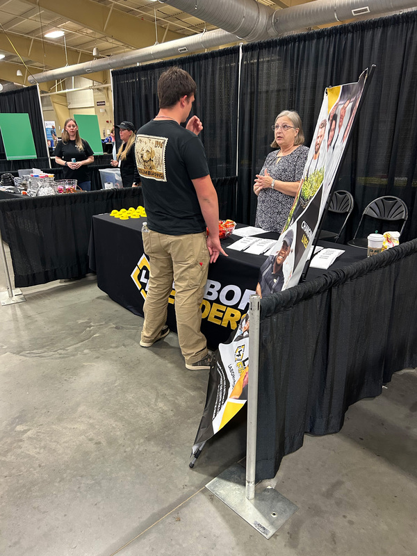 Student talking to business professionals. 