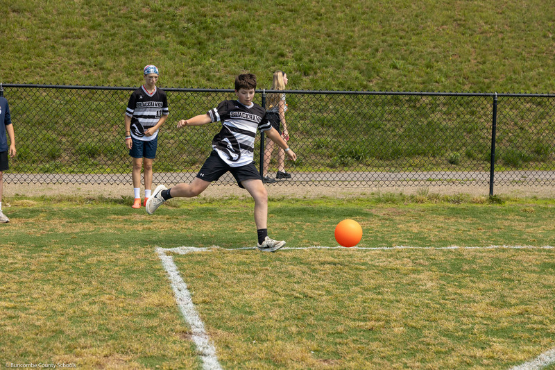 A kicker prepares to kick an incoming ball.