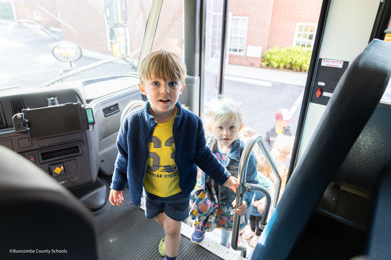 students getting on bus