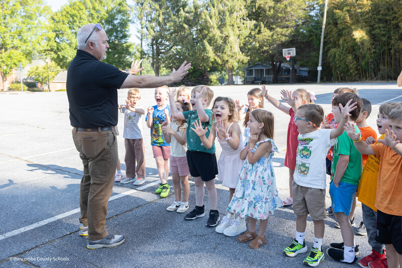 students learning hand signals from transportation director