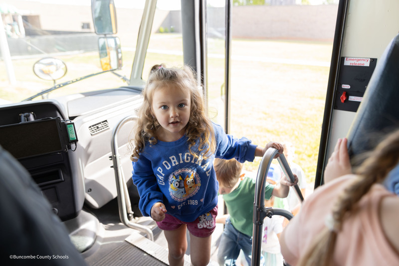 student getting on bus