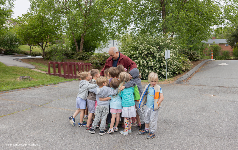 students give jeremy a group hug