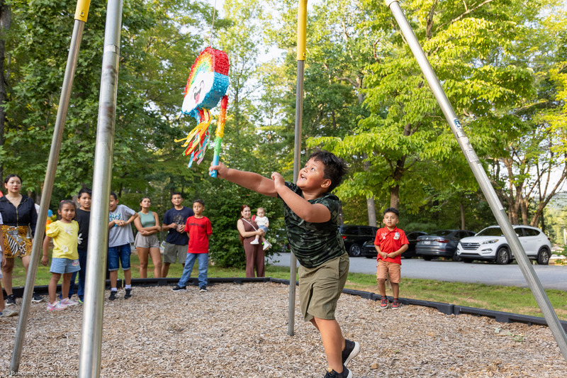 A boy swings at a pinata.