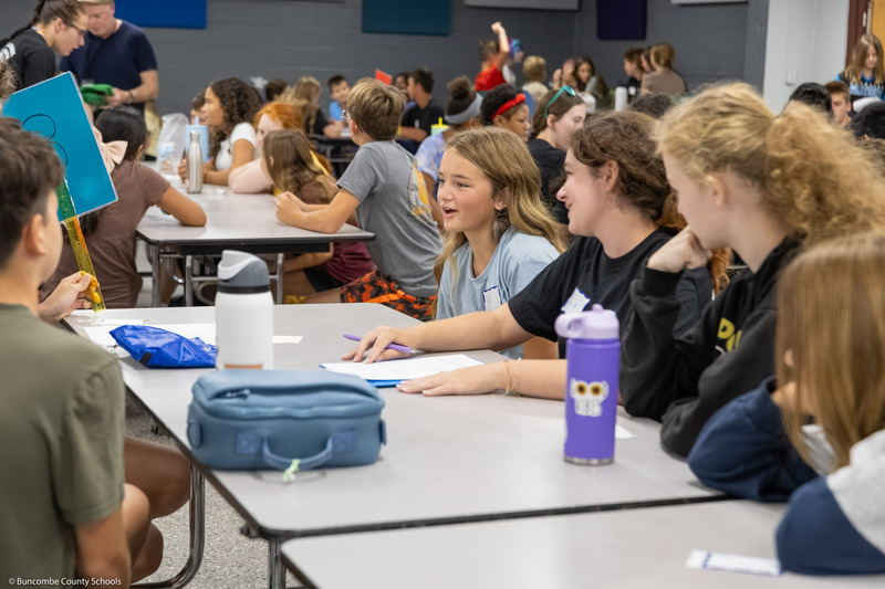 A sixth grade girl speaks with other sixth graders in the Owen Middle School cafeteria.
