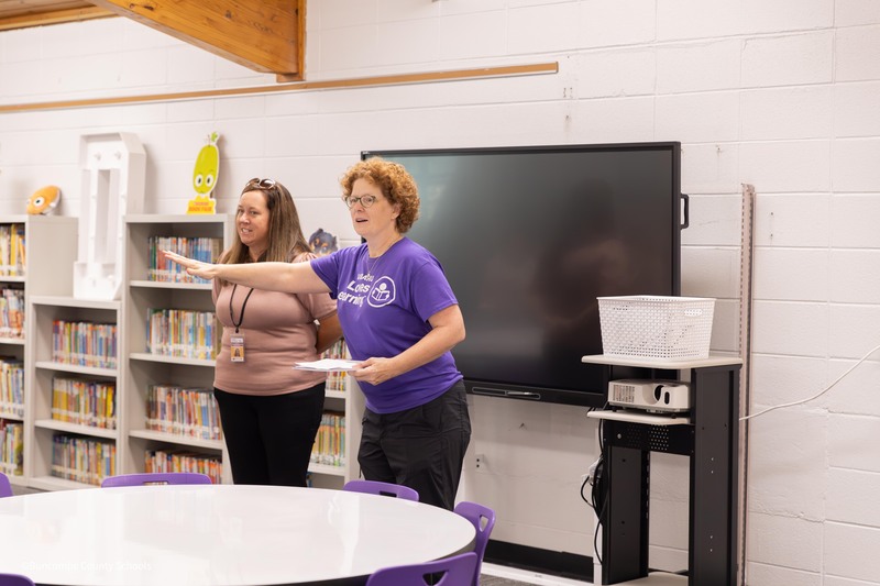 Kim hands out certificates to teachers