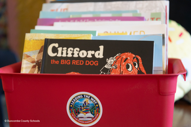 A close up of the sticker on a box of children's books that reads "Leading the Way - the Dr. Rob Jackson Leadership Collection."